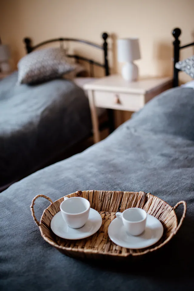 Une chambre calme avec deux tasses posées sur un plateau en osier